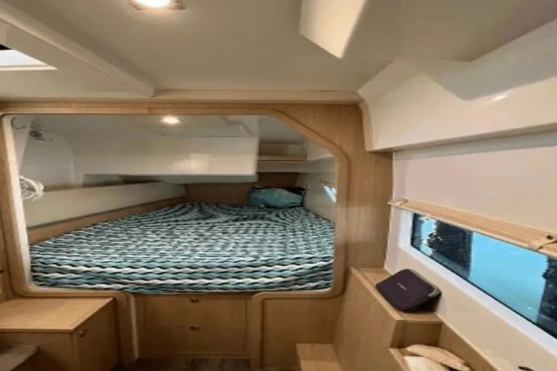  Yacht Photos Pics Interior cabin of 2022 Aquila 36 Cruiser with cozy bed and window view.