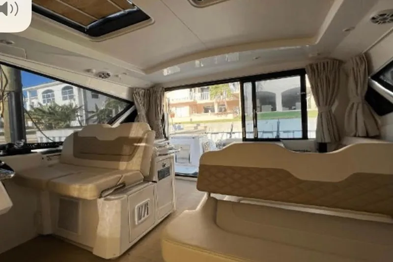  Yacht Photos Pics Interior of 2022 Aquila 36 Cruiser, featuring luxurious seating and large windows.
