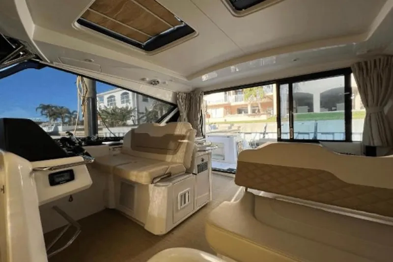  Yacht Photos Pics Interior of 2022 Aquila 36 Cruiser yacht, featuring luxurious seating and panoramic windows.