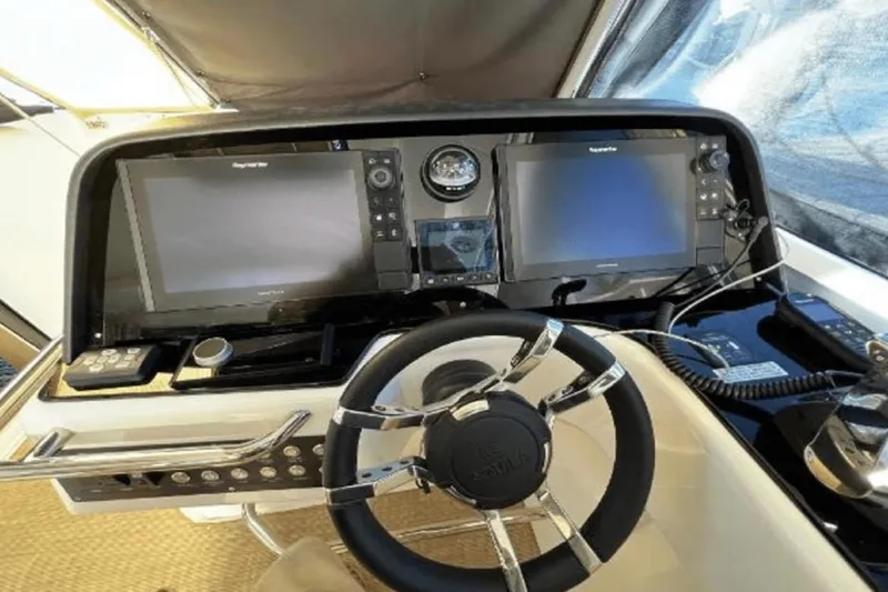  Yacht Photos Pics Helm of 2022 Aquila 36 Cruiser with dual navigation screens and modern controls.