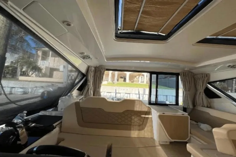  Yacht Photos Pics Interior of 2022 Aquila 36 Cruiser, featuring spacious seating and modern design elements.