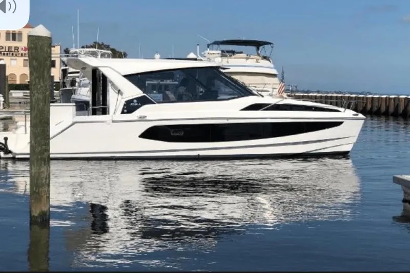  Yacht Photos Pics Aquila 36 Cruiser 2022 yacht docked in a marina, reflecting on calm water.