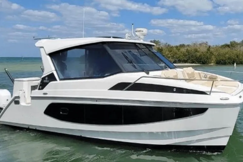  Yacht Photos Pics 2022 Aquila 36 Cruiser on calm water, featuring sleek design and modern amenities.
