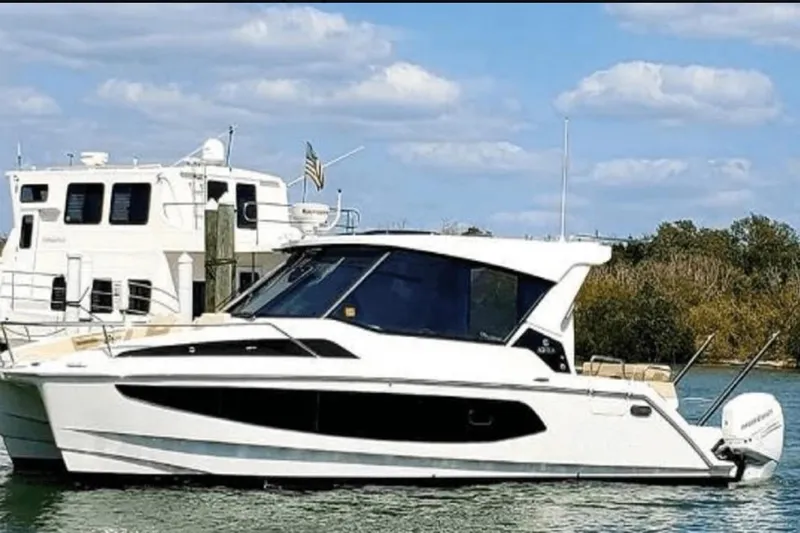  Yacht Photos Pics Aquila 36 Cruiser 2022 on water, sleek design, clear sky background.