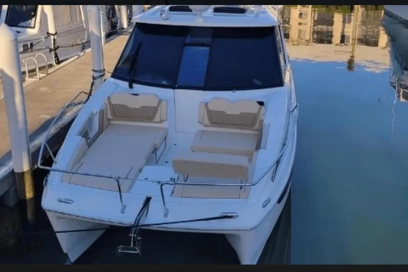  Yacht Photos Pics Aquila 36 Cruiser 2022 docked, featuring spacious deck seating and sleek design.