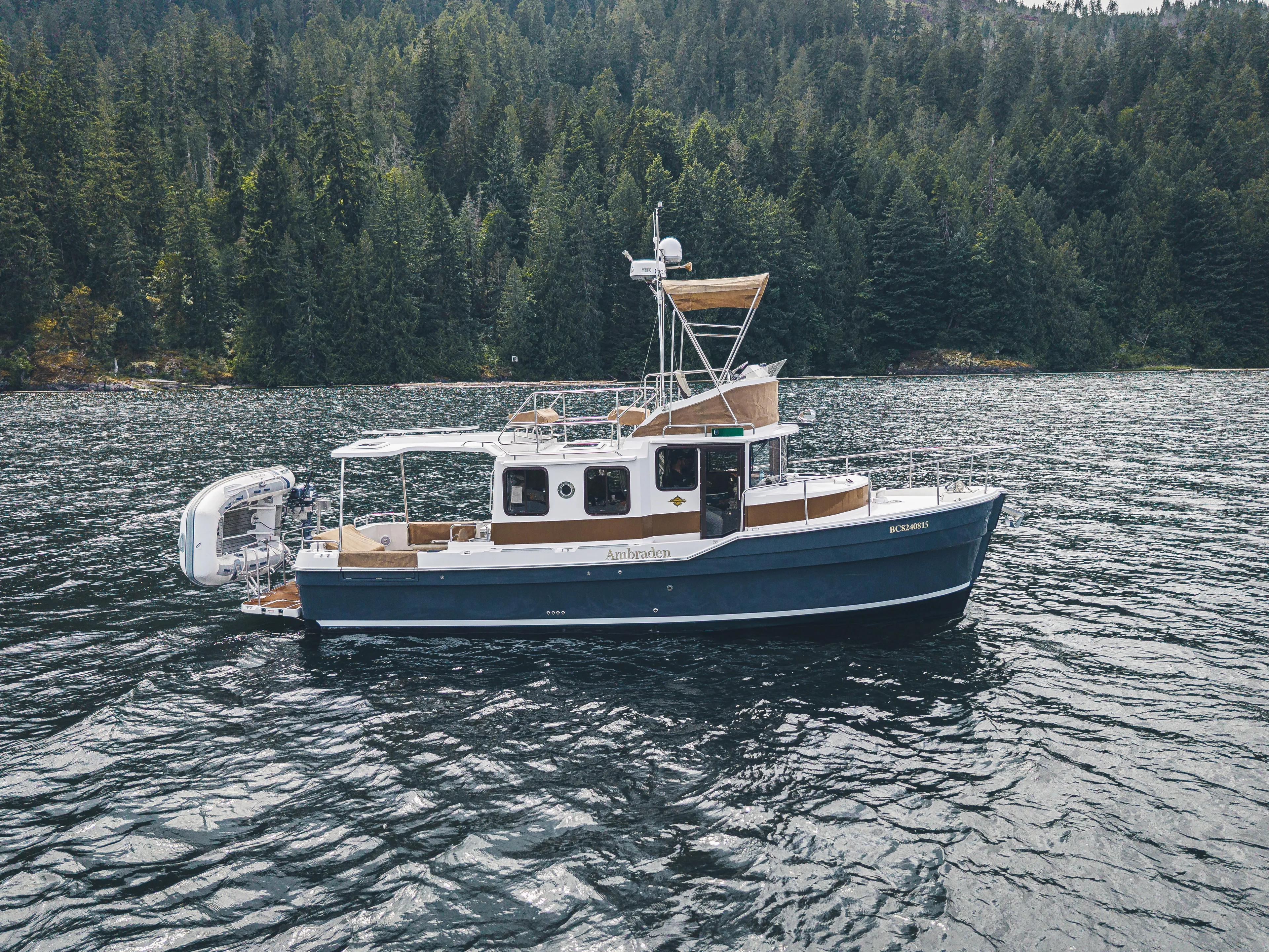 Ambraden Yacht Photos Pics 2022 Ranger Tugs R-31 CB boat on a scenic forested lake.