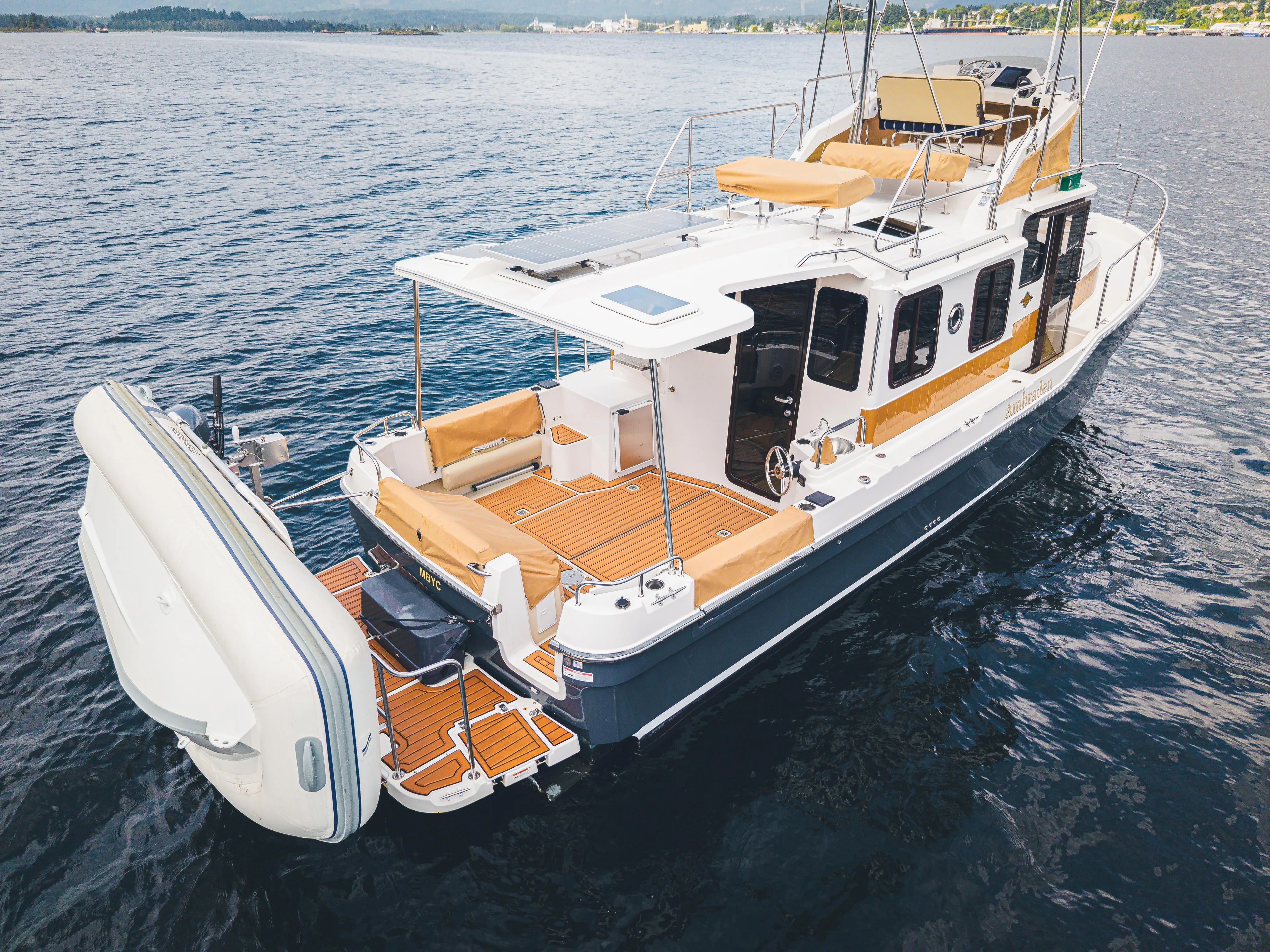 Ambraden Yacht Photos Pics 2022 Ranger Tugs R-31 CB boat on water, featuring spacious deck and modern design.