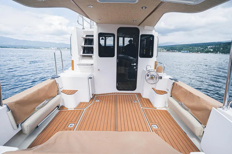 Ambraden Yacht Photos Pics 2022 Ranger Tugs R-31 CB boat interior with teak deck, overlooking serene waters.