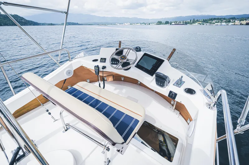 Ambraden Yacht Photos Pics 2022 Ranger Tugs R-31 CB helm with modern controls on a scenic waterway.