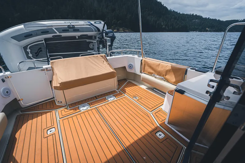 Ambraden Yacht Photos Pics 2022 Ranger Tugs R-31 CB boat deck with scenic lake and forest backdrop.