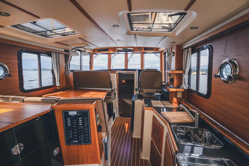 Ambraden Yacht Photos Pics Luxurious interior of 2022 Ranger Tugs R-31 CB with wood finish and modern amenities.