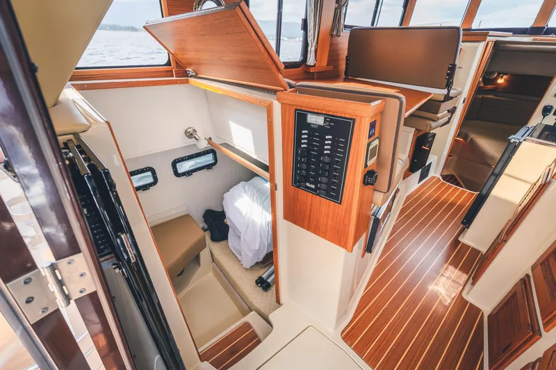 Ambraden Yacht Photos Pics 2022 Ranger Tugs R-31 CB interior with wood accents and control panel.