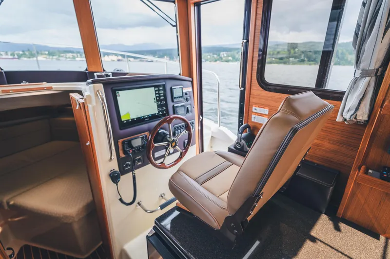 Ambraden Yacht Photos Pics 2022 Ranger Tugs R-31 CB helm with modern navigation system and comfortable seating.