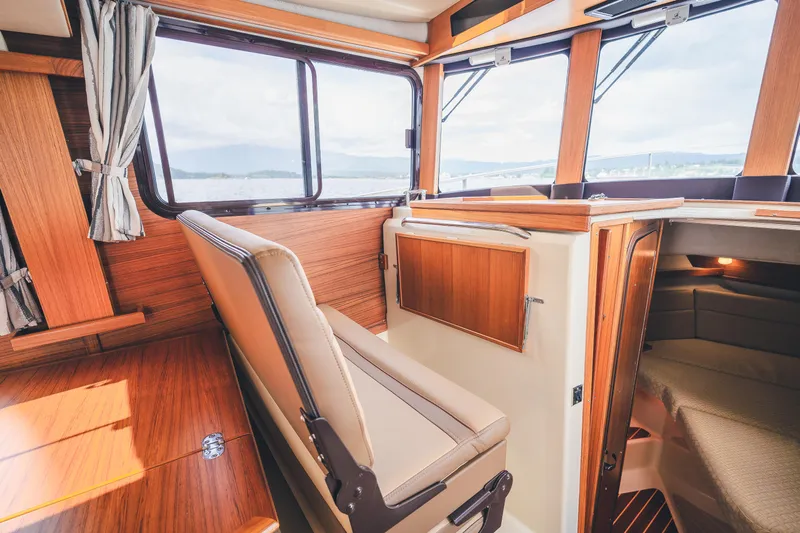 Ambraden Yacht Photos Pics Interior of 2022 Ranger Tugs R-31 CB, featuring wood finishes and seating.