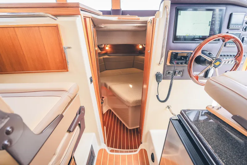 Ambraden Yacht Photos Pics Interior of 2022 Ranger Tugs R-31 CB, featuring helm, cabin, and wood accents.