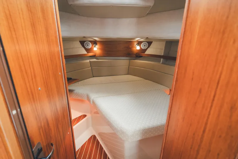 Ambraden Yacht Photos Pics 2022 Ranger Tugs R-31 CB cabin interior with cozy bed and wooden finish.