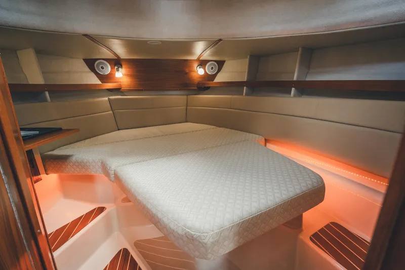 Ambraden Yacht Photos Pics 2022 Ranger Tugs R-31 CB cabin interior with cozy bed and ambient lighting.