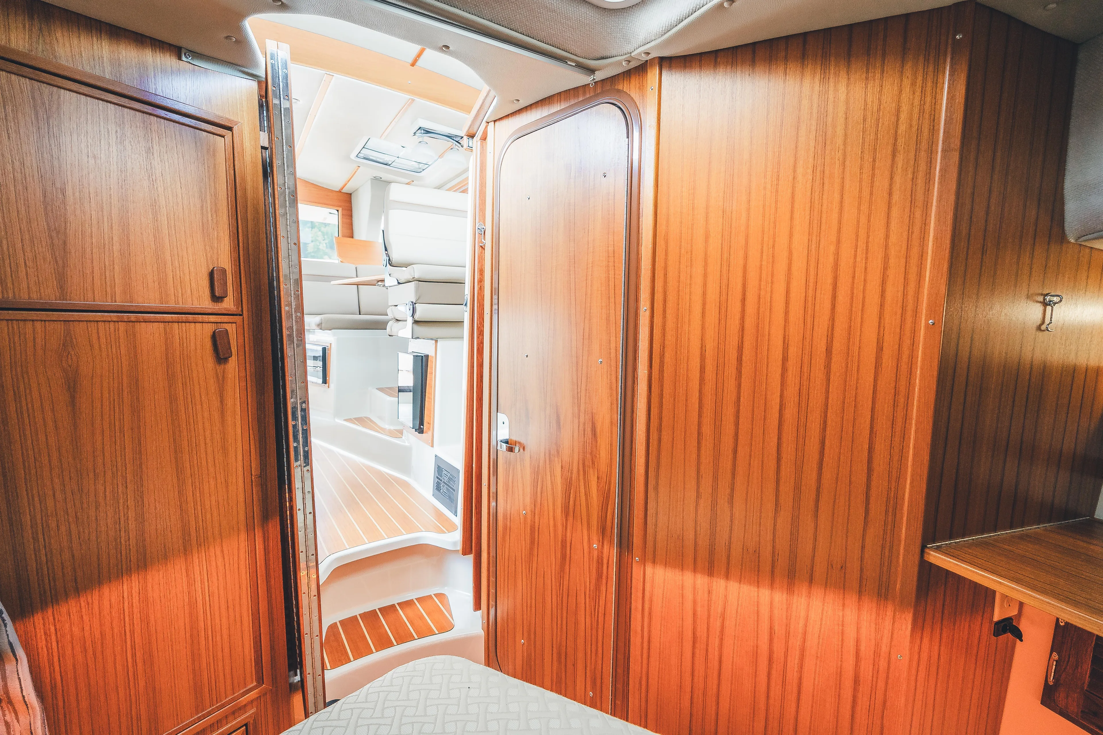 Ambraden Yacht Photos Pics Interior of 2022 Ranger Tugs R-31 CB, featuring wooden paneling and cozy cabin space.