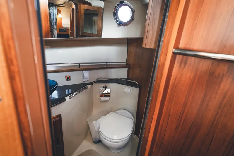 Ambraden Yacht Photos Pics 2022 Ranger Tugs R-31 CB bathroom with wooden cabinetry and modern fixtures.