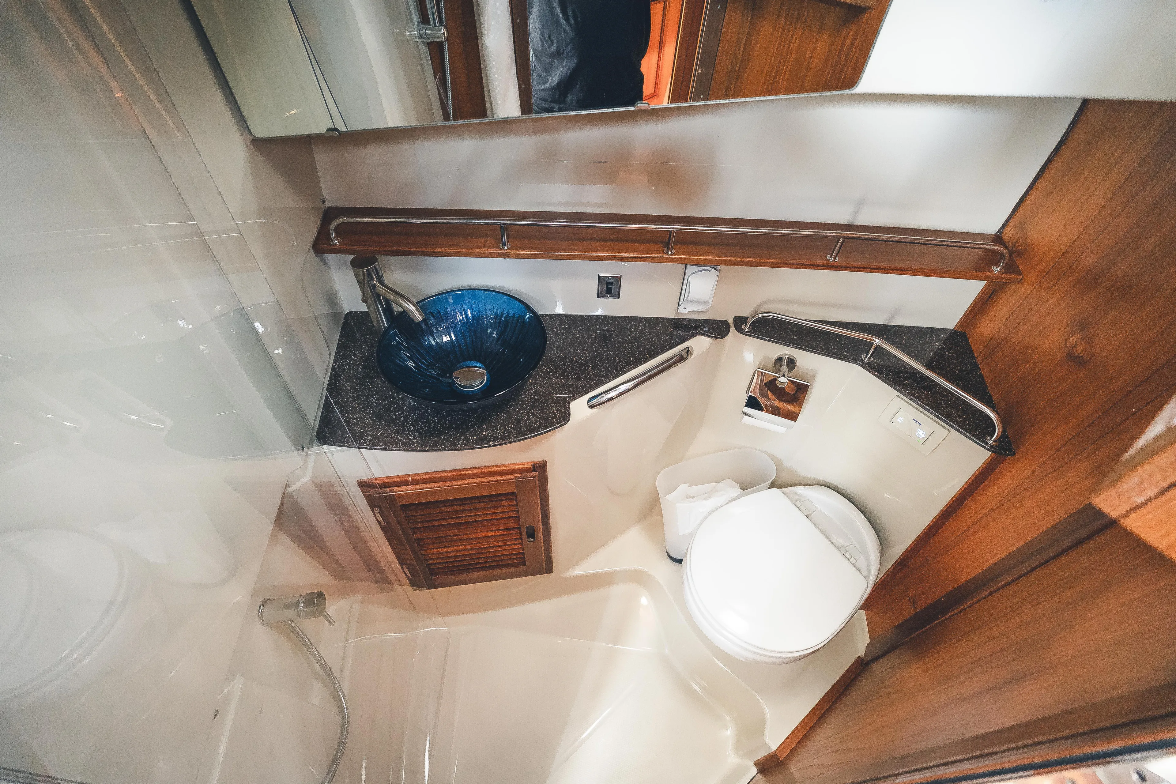 Ambraden Yacht Photos Pics 2022 Ranger Tugs R-31 CB bathroom with modern sink, toilet, and wood accents.
