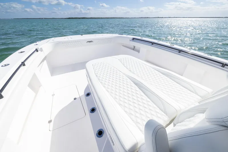  Yacht Photos Pics 2025 Invincible 35 Catamaran with luxurious white seating on open water.