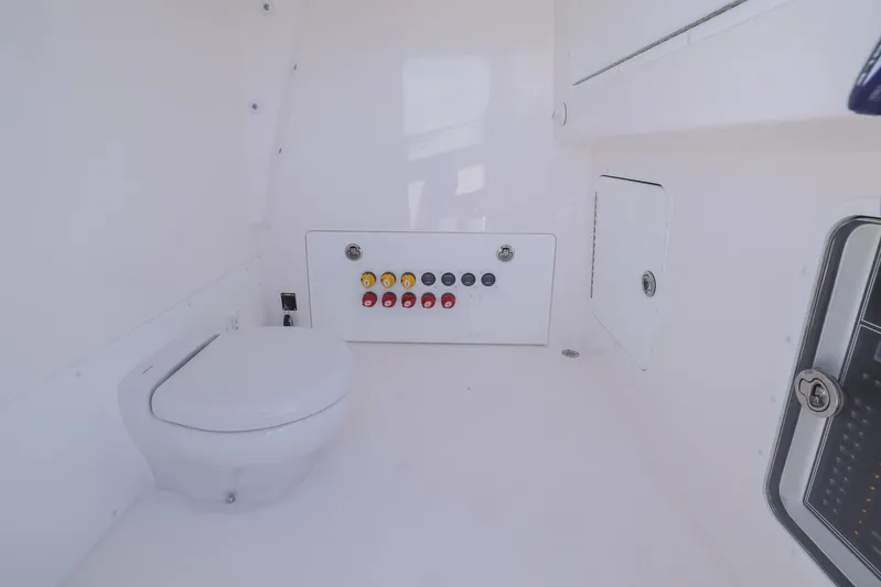  Yacht Photos Pics 2025 Invincible 35 Catamaran interior with modern marine toilet and control panel.