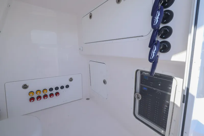  Yacht Photos Pics Interior view of 2025 Invincible 35 Catamaran with control panel and storage compartments.