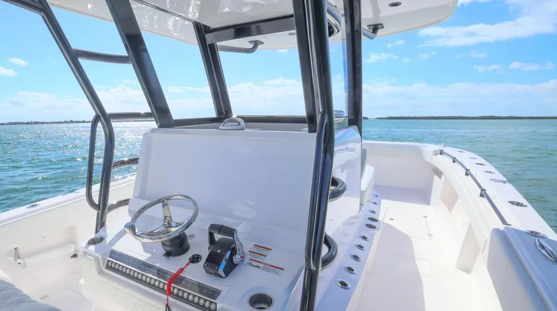  Yacht Photos Pics 2025 Invincible 35 Catamaran on open water, showcasing sleek design and modern controls.