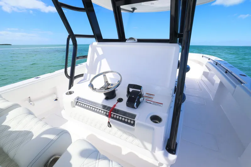  Yacht Photos Pics 2025 Invincible 35 Catamaran helm with ocean view, featuring modern controls and seating.