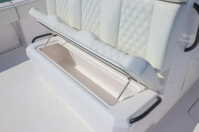  Yacht Photos Pics 2025 Invincible 35 Catamaran seat with storage compartment, featuring quilted upholstery.