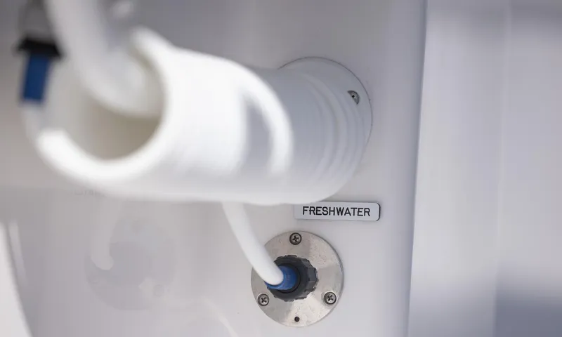  Yacht Photos Pics Freshwater connection on 2025 Invincible 35 Catamaran, featuring white hose and labeled port.