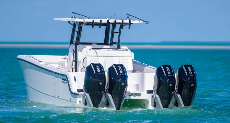  Yacht Photos Pics 2025 Invincible 35 Catamaran with quad engines cruising on turquoise waters.