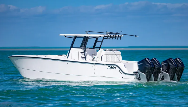  Yacht Photos Pics 2025 Invincible 35 Catamaran cruising on turquoise waters with triple outboard engines.