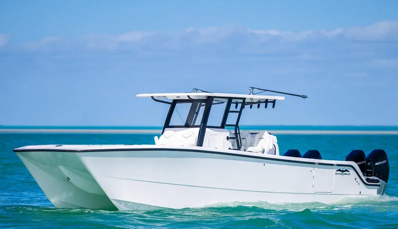 Yacht Photos Pics 2025 Invincible 35 Catamaran cruising on clear blue waters.