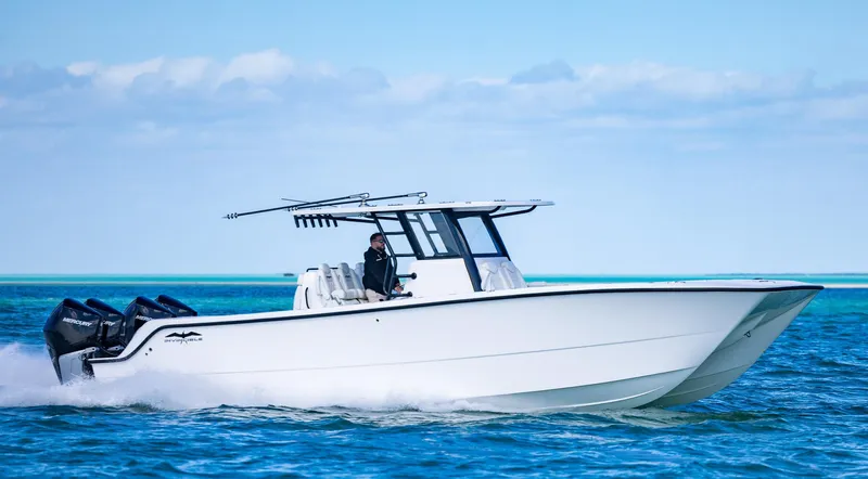  Yacht Photos Pics 2025 Invincible 35 Catamaran cruising on open water, showcasing sleek design and powerful engines.