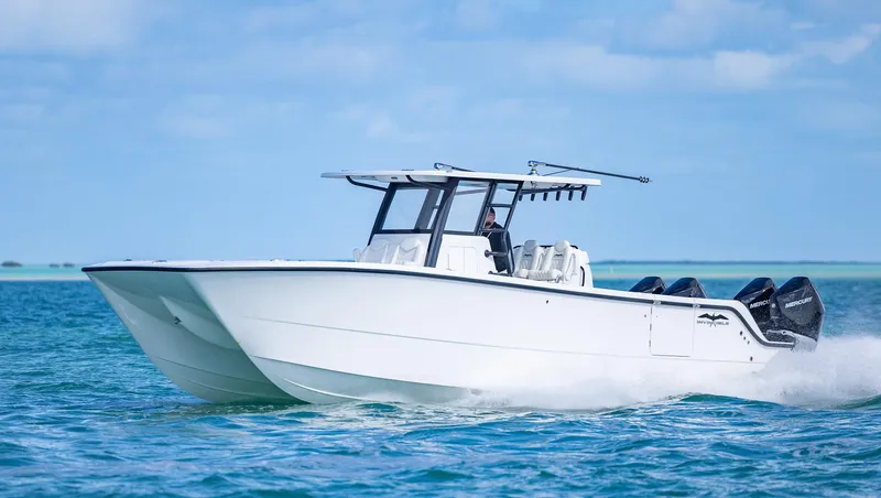  Yacht Photos Pics 2025 Invincible 35 Catamaran cruising on clear blue waters.