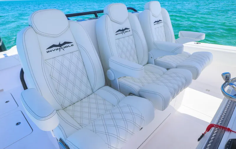 Yacht Photos Pics Luxurious seating on 2025 Invincible 35 Catamaran, featuring white leather and ocean backdrop.