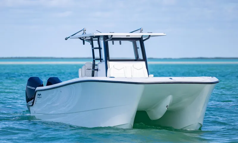  Yacht Photos Pics 2025 Invincible 35 Catamaran on turquoise water, showcasing sleek design and twin engines.