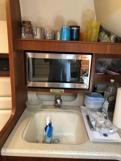 Reel Busy Yacht Photos Pics 2006 Tiara Yachts 3800 Open galley with microwave, sink, and storage.