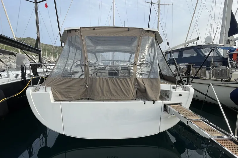  Yacht Photos Pics 2018 Hanse 588 yacht with covered cockpit, docked in a marina.