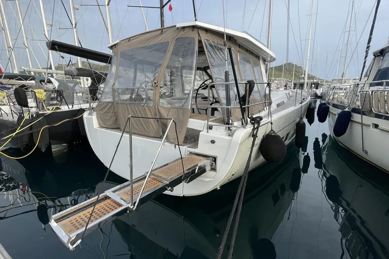  Yacht Photos Pics Hanse 588 yacht, 2018 model, docked in marina with protective canopy and gangway.