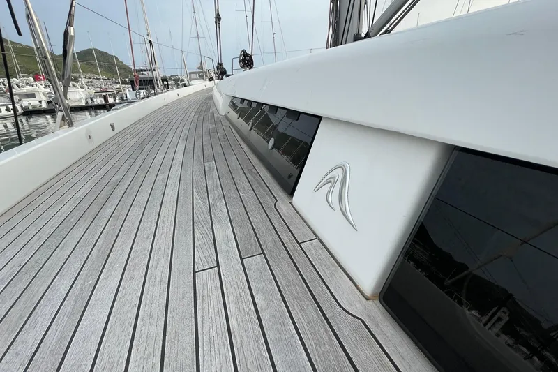  Yacht Photos Pics Deck view of 2018 Hanse 588 yacht in marina, showcasing sleek design and wood finish.