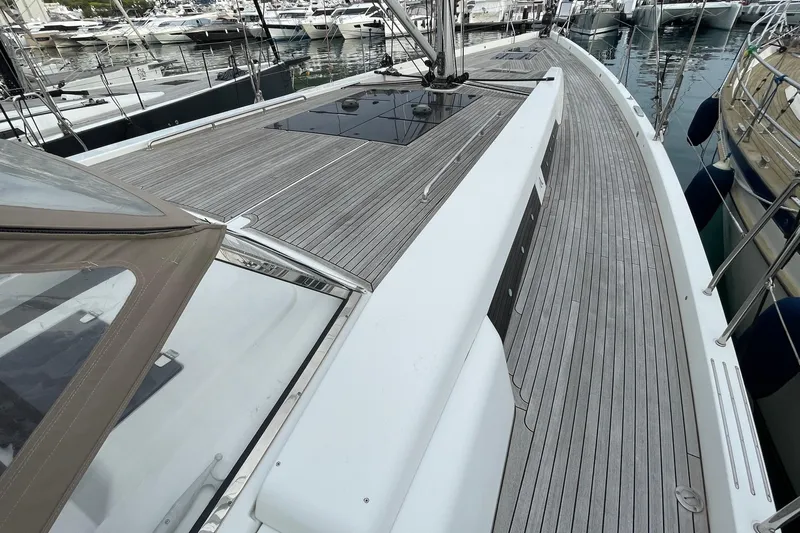  Yacht Photos Pics 2018 Hanse 588 yacht deck with sleek wooden finish, docked in a marina.