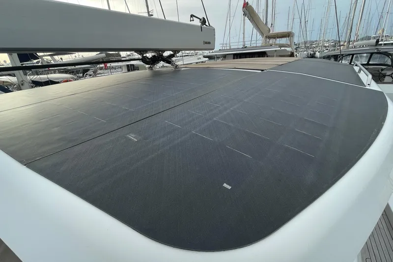  Yacht Photos Pics 2018 Hanse 588 yacht with solar panels on deck, docked in a marina.