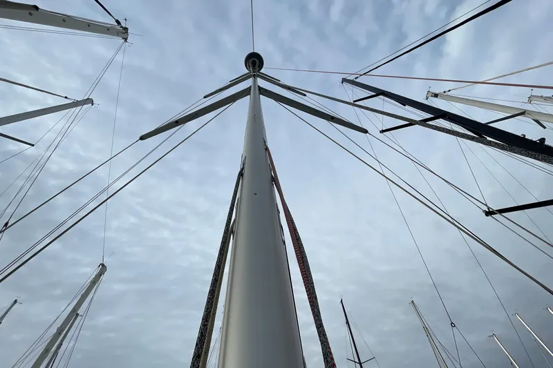  Yacht Photos Pics Mast of 2018 Hanse 588 sailboat against cloudy sky, showcasing rigging and sails.