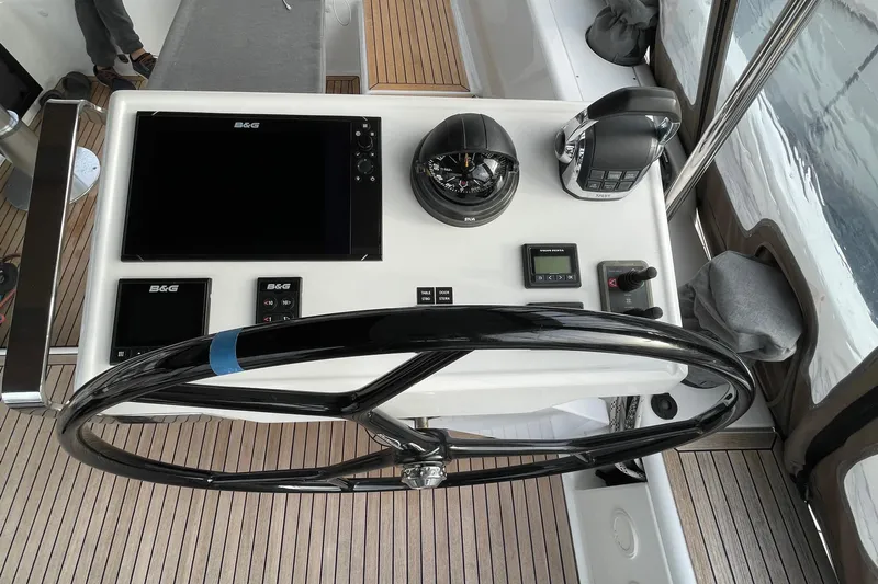  Yacht Photos Pics Helm station of 2018 Hanse 588 yacht with navigation equipment and steering wheel.
