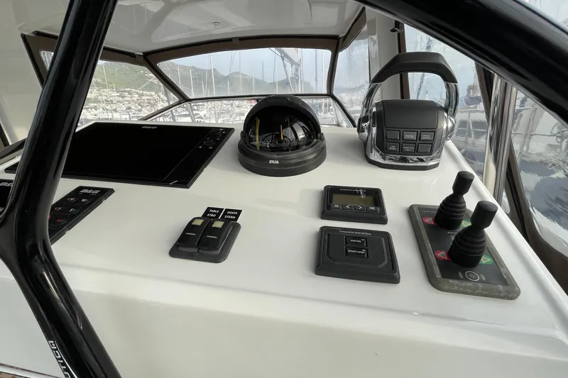  Yacht Photos Pics Control panel of a 2018 Hanse 588 yacht with navigation instruments and throttle controls.