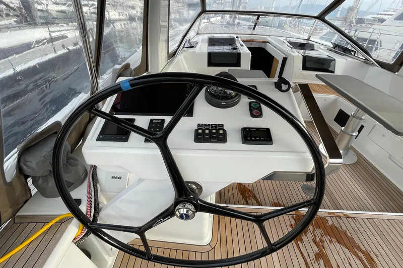  Yacht Photos Pics Steering wheel and controls of 2018 Hanse 588 yacht, featuring modern navigation equipment.