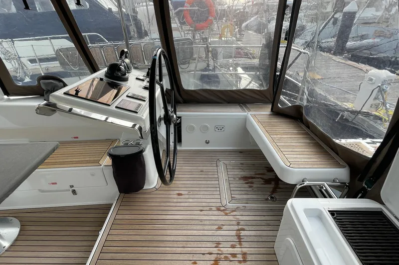  Yacht Photos Pics Cockpit of 2018 Hanse 588 yacht with wooden flooring and steering wheel.