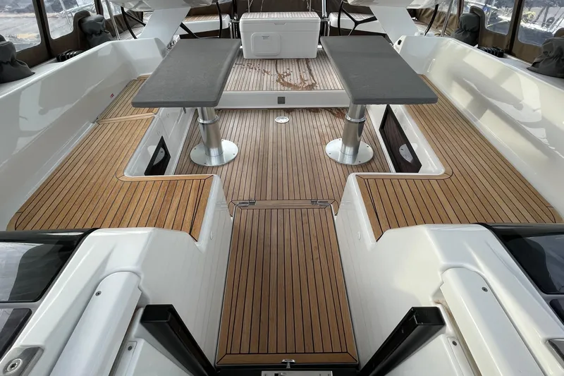 Yacht Photos Pics Spacious deck of 2018 Hanse 588 yacht with wooden flooring and dual tables.